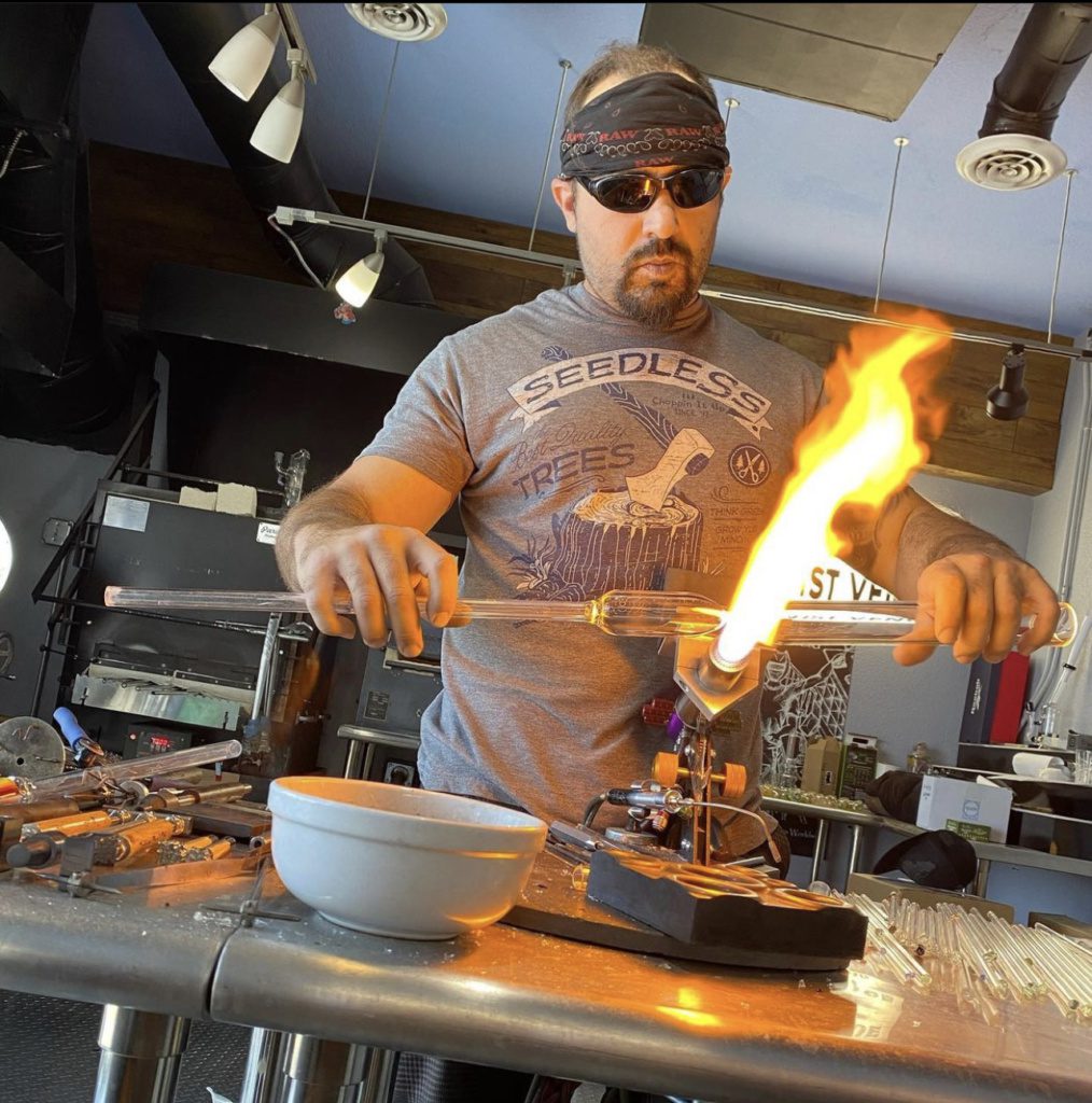 Artisan glass blower at It's All Goodz Smoke Shop North Phoenix, crafting unique pieces for the premier smoke shop in Phoenix.